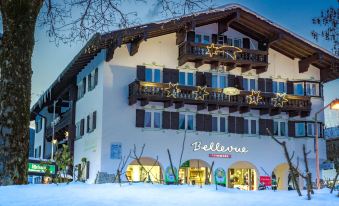 "a snow - covered building with a sign that says "" fallebre "" and numerous snowmen in front of it" at Hotel Bellevue
