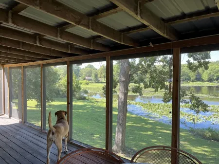 Relax at Grandma’s house with a screened in porch overlooking a private lake!