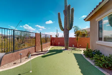 Southwestern stunner with enclosed yard, pool, putting green, & grill