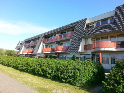 Ameland - apartment with balcony to the south side with a view of meadows and the village of Buren Hotels in 