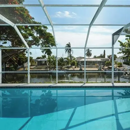 Canalfront Retreat! 2BR + Bunk Nook, Pool & Boat Dock – Easy Water Access!
