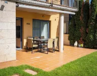 Villa in the mountains in front of a lake.