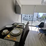 In front of Hospital U. de Chile with parking lot.