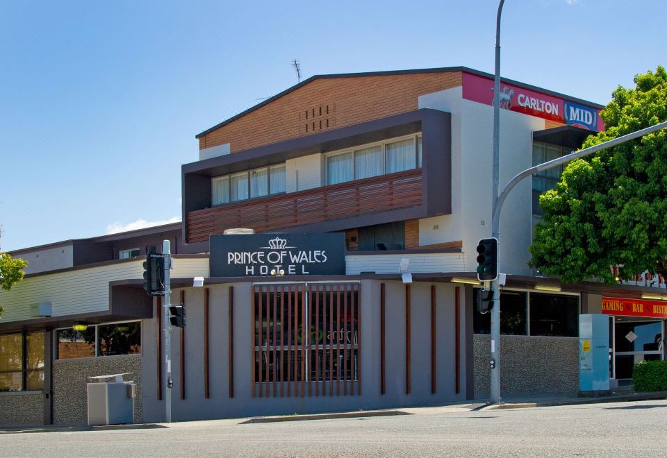 "a brick building with a sign that says "" peacy road estates "" in front of it" at Prince of Wales Hotel