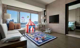 features a spacious room with large windows and a variety of toys scattered on the floor, creating an engaging and playful environment at Hangzhou Marriott Hotel Qianjiang