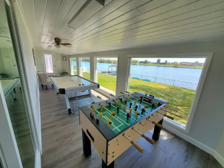 Lakefront Getaway. Private Waterfront Home with Dock and Sunroom.