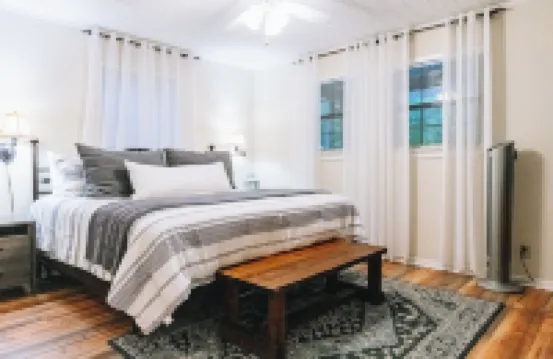 Luxurious cabin with fire pit, kayaks, and dock.