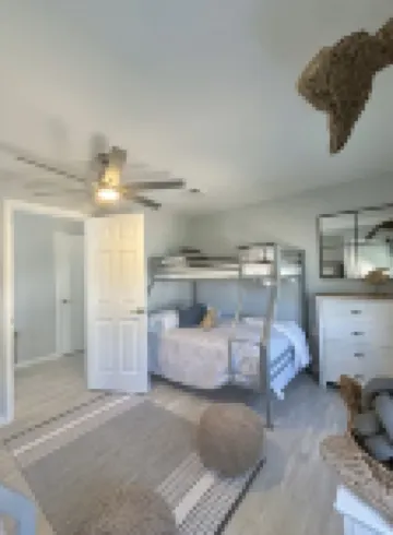 Relax here with beach views, steps to the beach, fenced in yard, pet friendly