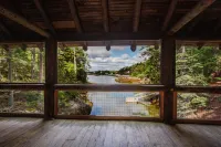 Renovated 3-BR boathouse built atop water in quiet cove; private float & trails - Wifi