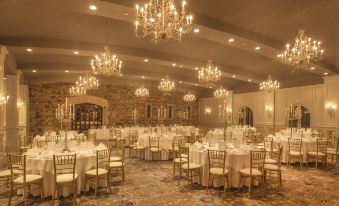 a large , elegant banquet hall with numerous tables and chairs set up for a formal event at Kilkea Castle