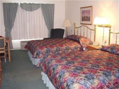 a hotel room with two beds , one on the left and one on the right side of the room at Country Inn & Suites by Radisson, Watertown, SD