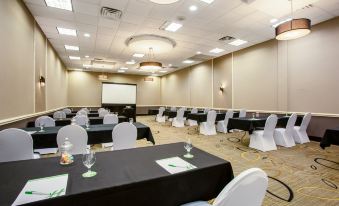 a conference room set up for a meeting , with chairs arranged in rows and a whiteboard on the wall at Holiday Inn Morgantown - Reading Area