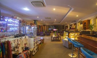 a spacious room with a high ceiling , numerous shelves filled with products , and a few people in the room at Hotel Somadevi Angkor Resort & Spa