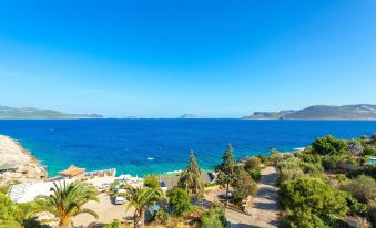 a beautiful view of the ocean , with a clear blue sky above , and several boats floating on the water at Aquarius Hotel