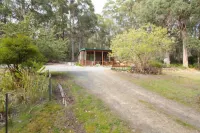 The Cabin-Wake up to the sound of native birdlife.