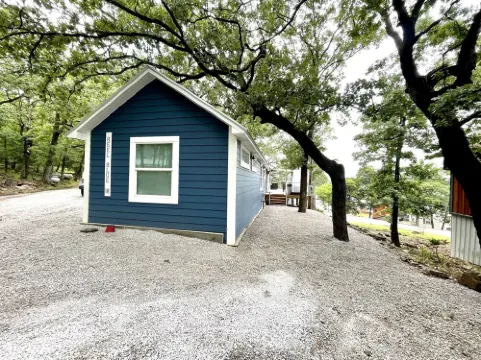 SHORT WALK TO WATER & NESTLED IN THE TREES THIS BEAUTIFUL CABIN HAS LAKE VIEWS