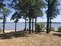 Private lakefront getaway with a sandy beach below the back deck!