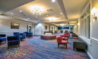 a large , well - lit room with a carpeted floor and multiple couches arranged in various positions at Gettysburg Hotel