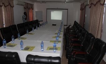 a conference room with a long table , chairs , and water bottles set up for a meeting at Blue Hill Hotel