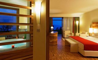 a modern living room with a red couch and a staircase leading to a bedroom at Lefay Resort & Spa Lago di Garda