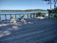 Cozy waterfront log cottage with huge outdoor living area.