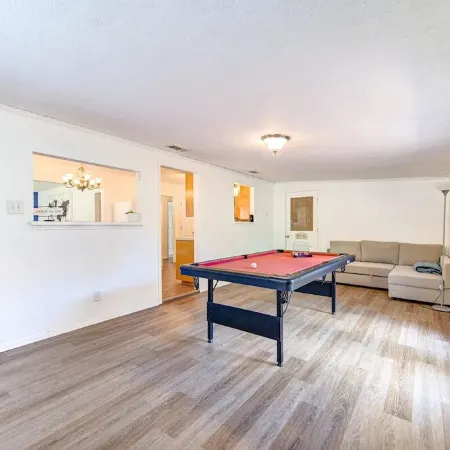 King bed with Pool table, decked patio and, gym.