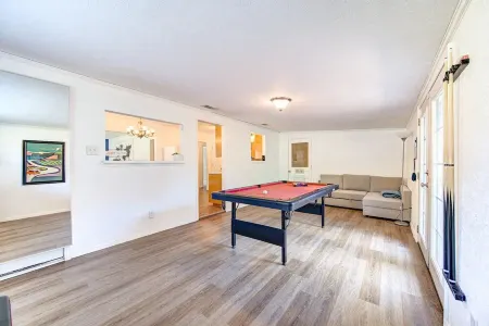 King bed with Pool table, decked patio and, gym.