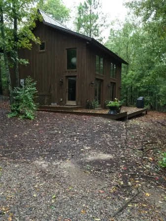 Stunning and private mid-century modern inspired cottage nestled in the woods.
