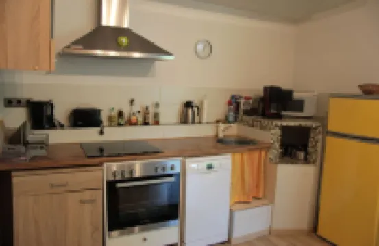 Modernly Furnished Bungalow with Fireplace, Surrounded by Greenery.