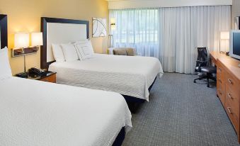 a hotel room with two beds , one on the left side and the other on the right side of the room at Courtyard Montvale
