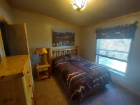 Location!  Nice log home in dark sky community next to several peaks