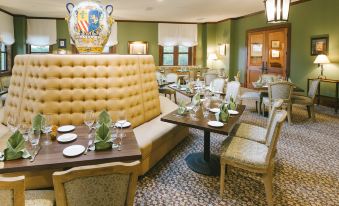 a dining room with a large yellow couch and chairs , creating a comfortable seating area for guests at Hotel Viata