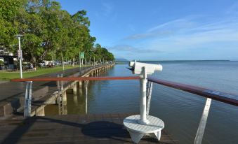 a long pier extending into a body of water , with a telescope on the pier at Trinity Links Resort