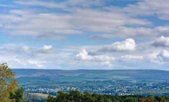 a panoramic view of a small town nestled in a valley with green fields and blue skies at Home2 Suites by Hilton Dickson City Scranton