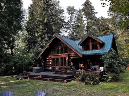 Luxury Riverfront Log Cabin Near Stevens Pass with Hot Tub & Two-Story Fireplace