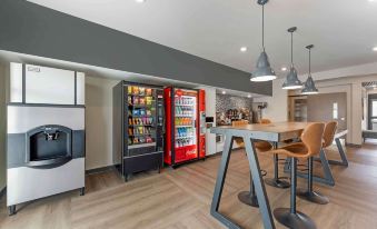 An open concept kitchen is a room that features tables, chairs, and refrigerators in the center at Extended Stay America Suites - Huntsville - Madison