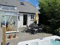 Honeysuckle Cottage with optional hot tub and shared EV charger.