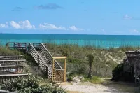 Beachfront 2-bedroom townhome, private beach access, outdoor space & amenities.
