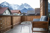 Modern chalet with a wraparound balcony with majestic views of the mountains