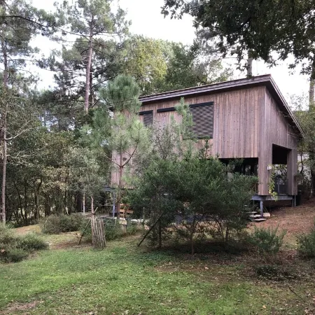 Wooden house in the golf, between forest, lake and ocean