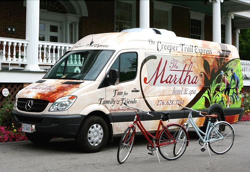 "a van with a sign that says "" the charm that you 're on "" is parked next to a red bicycle" at The Martha Washington Inn and Spa