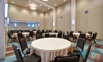 a large , well - lit room with multiple tables and chairs set up for a formal event at Home2 Suites by Hilton Atlanta Marietta