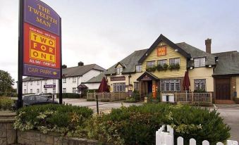 "a yellow building with a sign that reads "" the bluebell inn "" prominently displayed on the front of the building" at Premier Inn Wirral (Greasby)