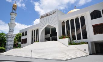 a white building with a large dome and arabic script on the side , surrounded by stairs at The Beehive