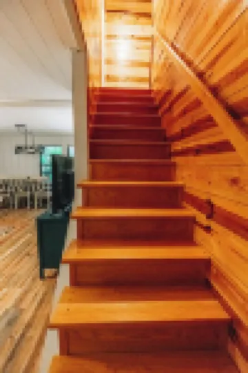 Luxurious cabin with fire pit, kayaks, and dock.