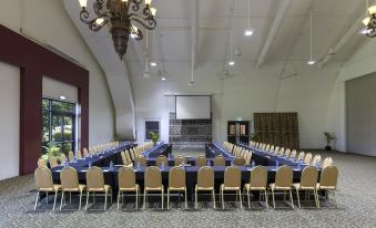 a large conference room with multiple rows of chairs arranged in a semicircle around a long table at Warwick le Lagon Resort & Spa, Vanuatu