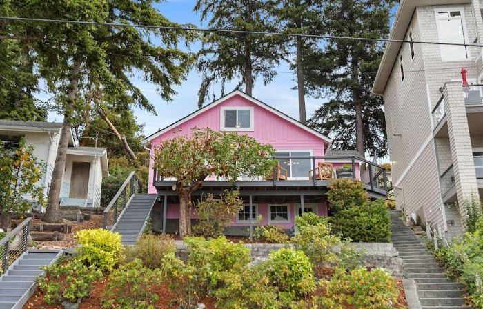 Darling pink beach house with epic views in a cozy community.