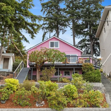 Darling pink beach house with epic views in a cozy community.