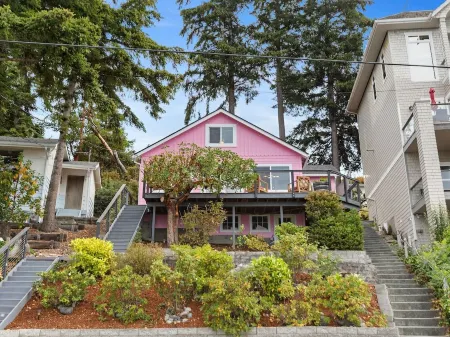 Darling pink beach house with epic views in a cozy community.
