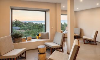 a modern living room with large windows overlooking a beautiful view , creating a warm and inviting atmosphere at Waterman Beach Village
